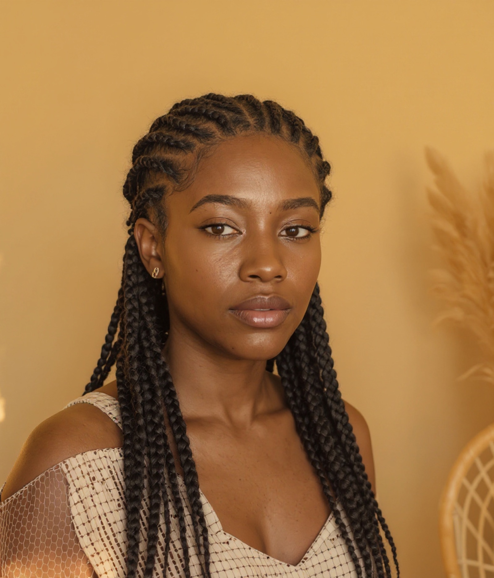 Long knotless box braids worn half-up, the same client after the install (sample result)