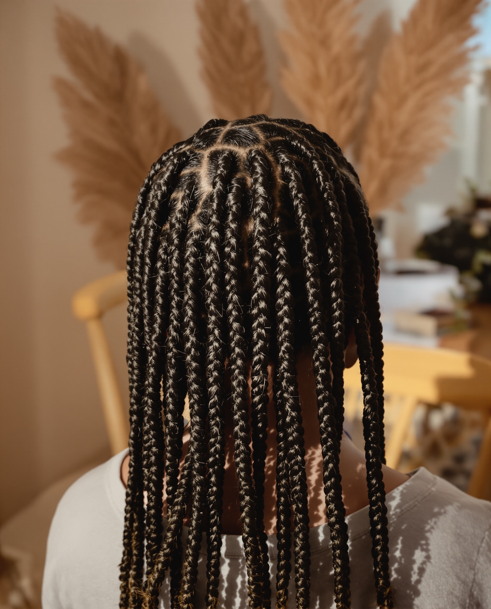 Close-up of knotless braids in neat square sections