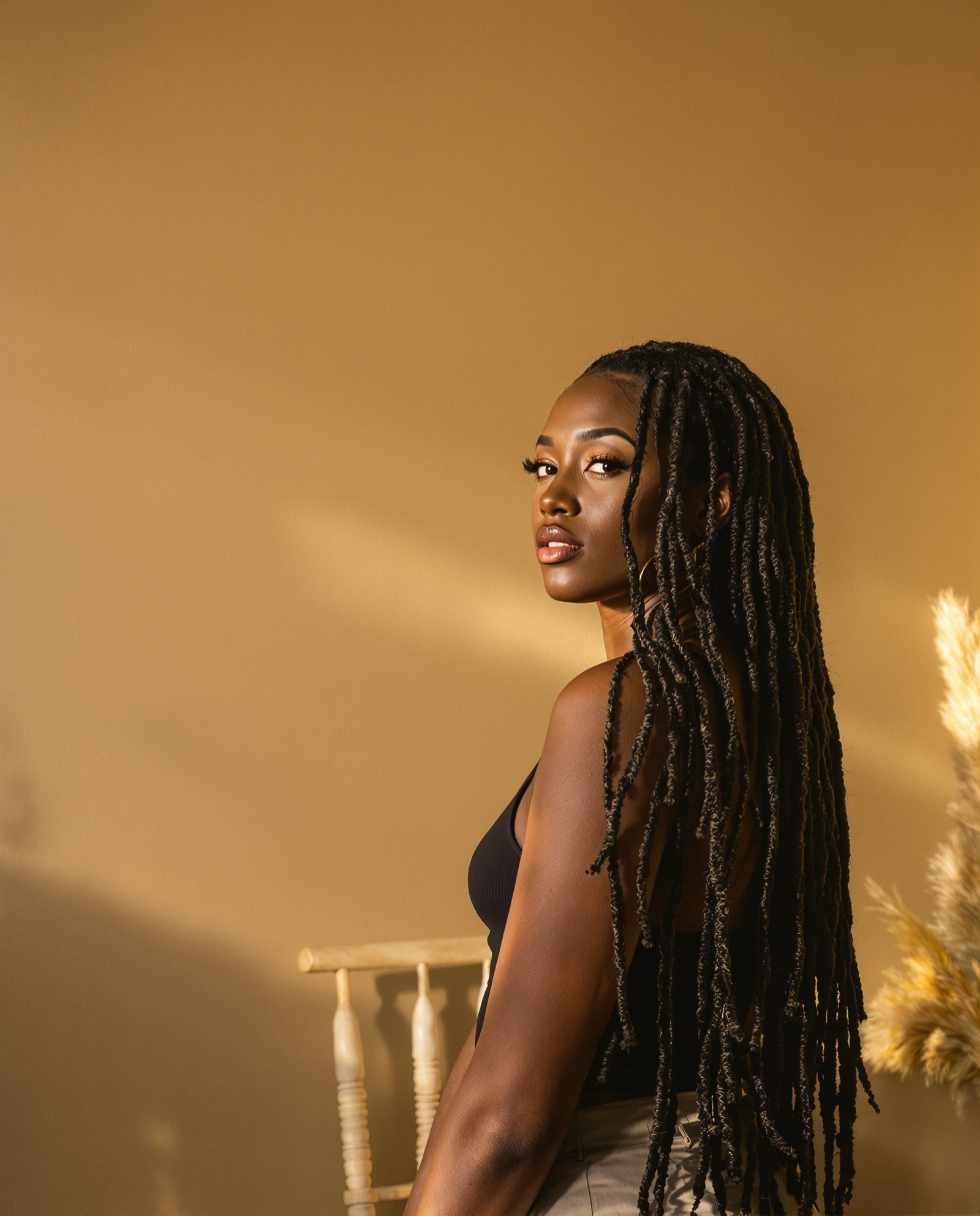 Long faux locs styled to one side